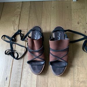 Free People brown and black heels with wrap ties around ankle. Size 8.